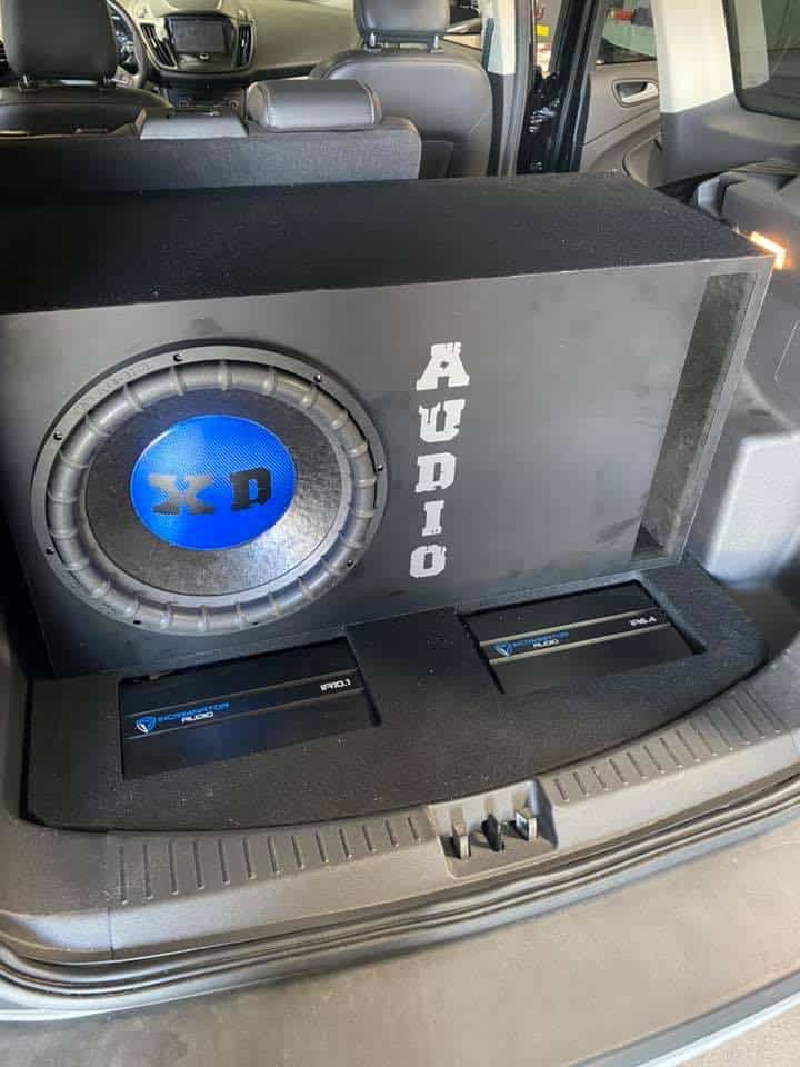 A custom subwoofer installed in the back of an SUV by XD Audio