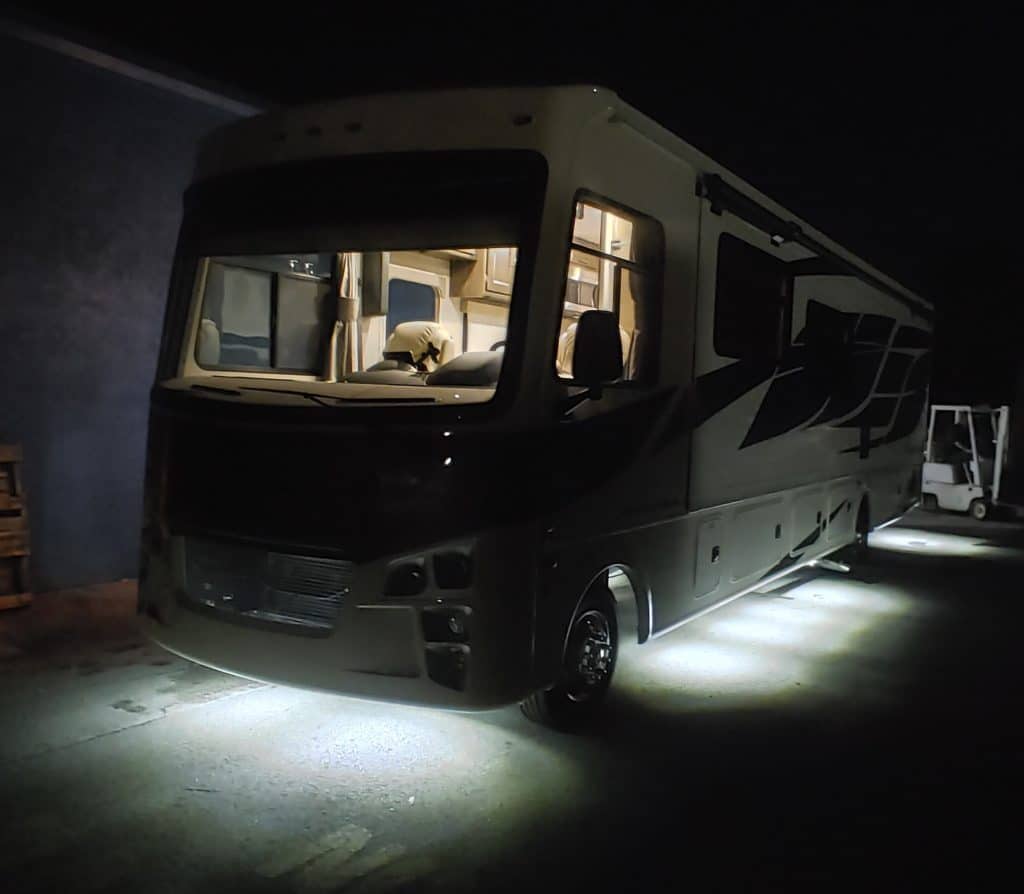 An RV with under lighting at night