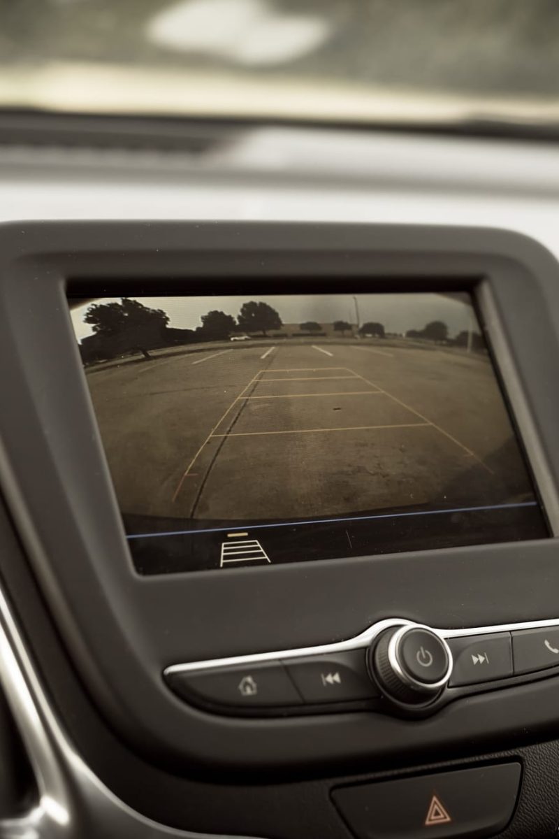 A backup camera helping the driver back out of a parking space in a parking lot.