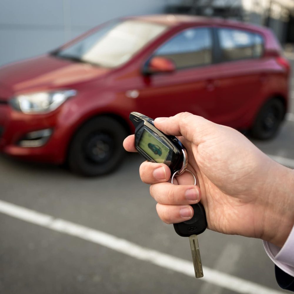 A man opening car with remote alarm key